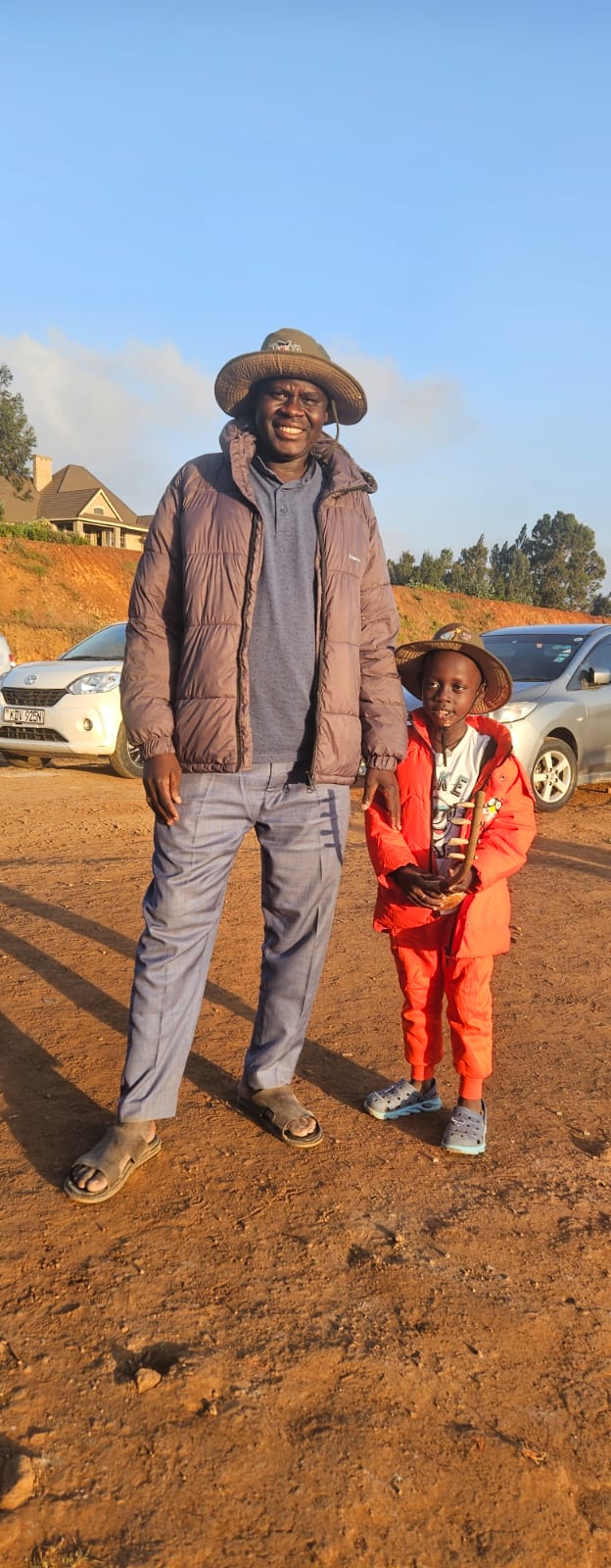 An adult and child together outdoors